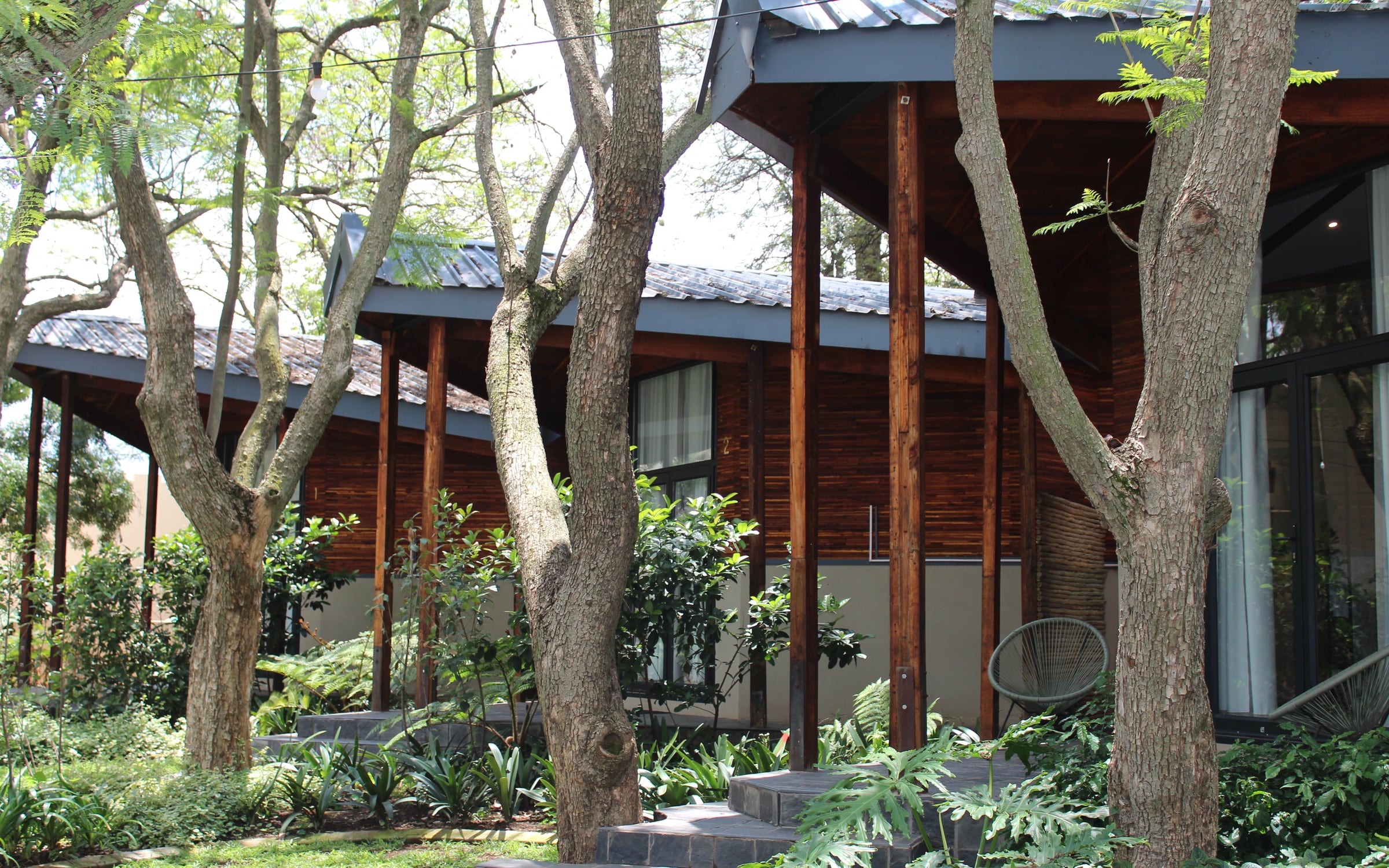 Reclaimed timber building among mature trees